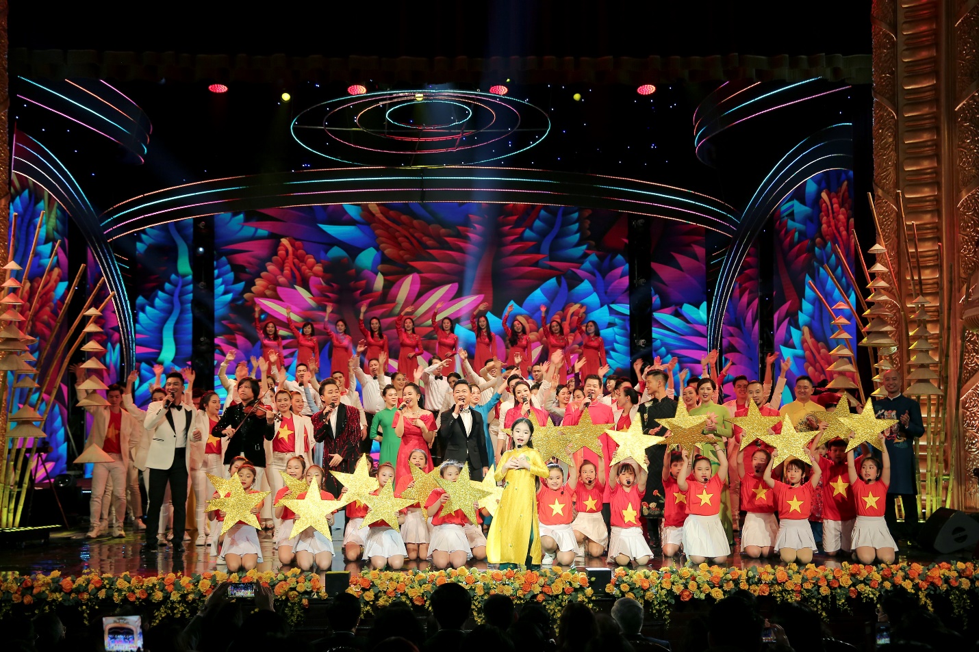 Description: A group of people performing on stage Description automatically generated